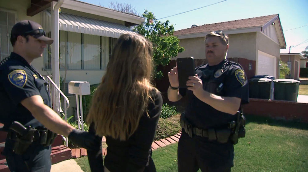 Officer Rob Halverson of the Chula Vista police verifies the identity of a ...