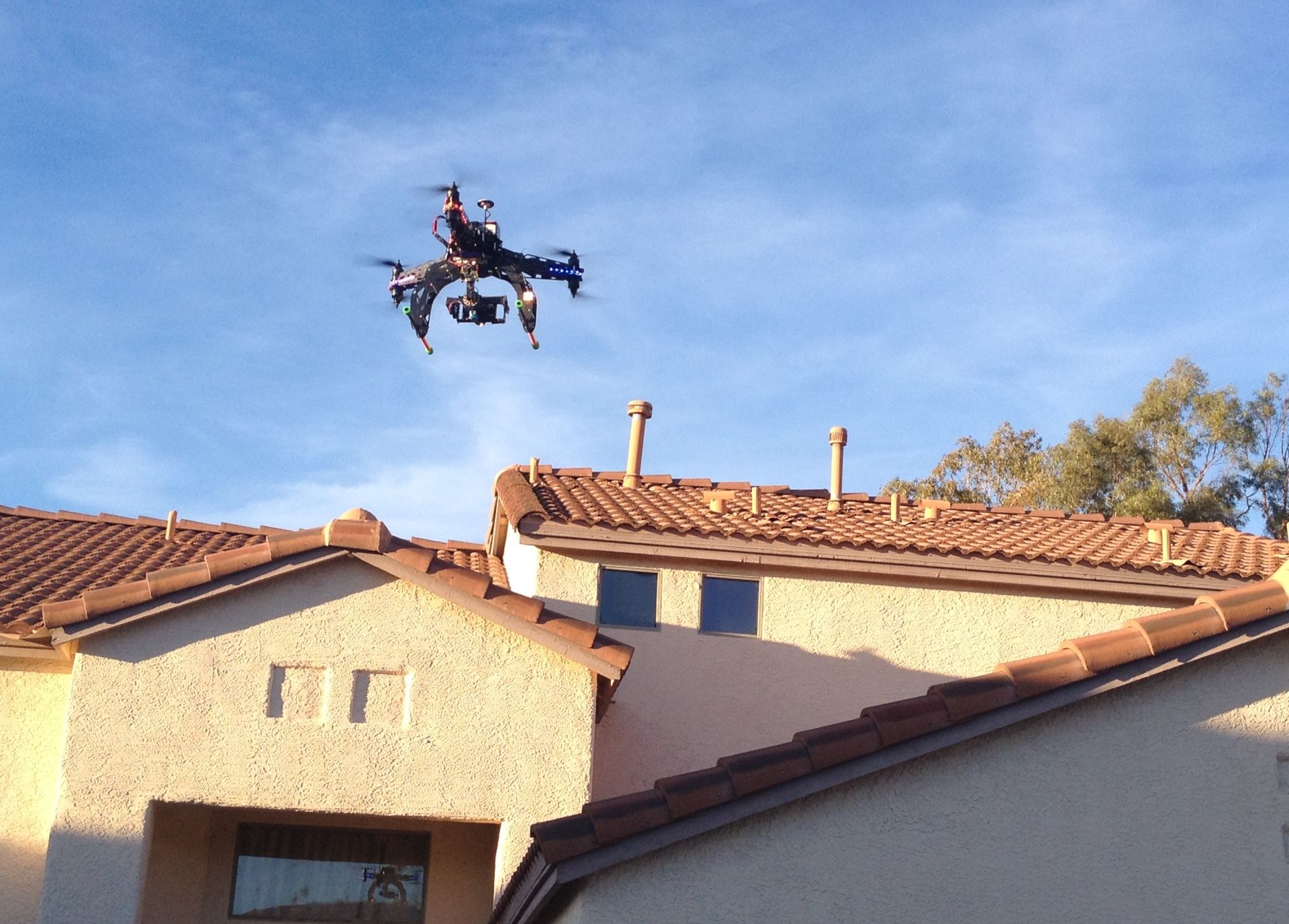 File photo of a unmanned aircraft, or drone, flying over a house.