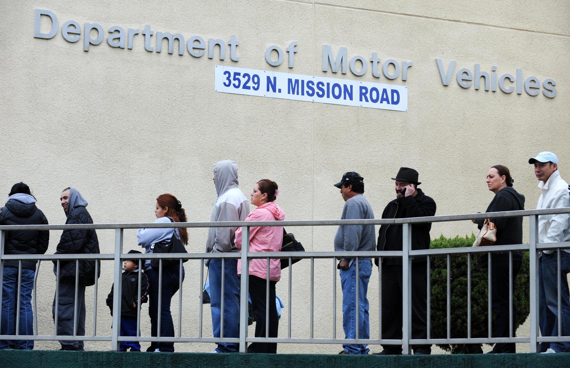 People wait in line outside a DMV branch in Los Angeles.