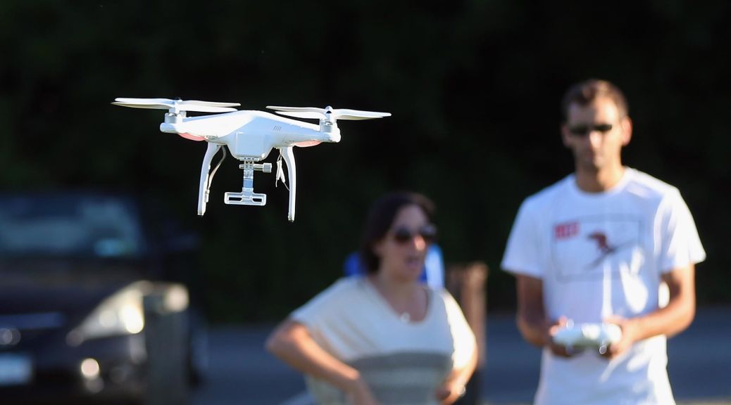 An enthusiast flies a recreational drone.