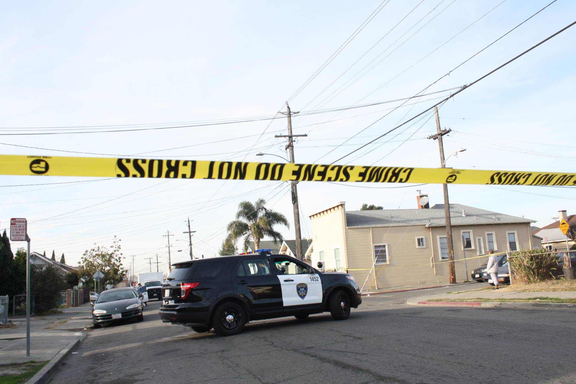 An Oakland Police Department vehicle parked at a crime scene.