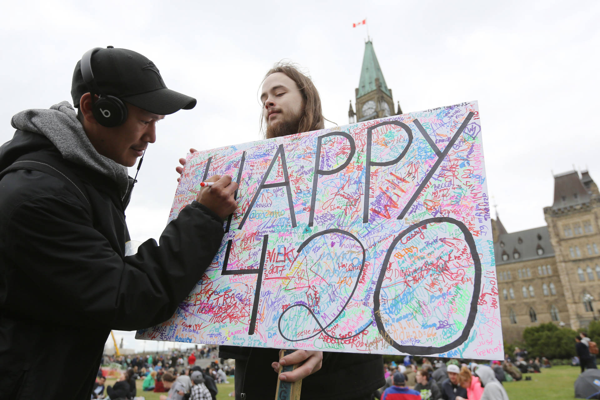 A guy holding a 420 sign