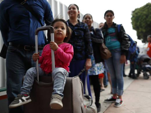 Asylum seekers line up at the San Ysidro port of entry in Tijuana, Mexico. The ACLU announced today a preliminary agreement with the Trump administration to allow some parents already in the U.S. but separated from their children at the border to apply for asylum.