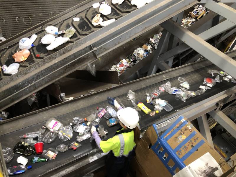 An employee sorts plastics at the Recology recycling plant on Pier 96 in San Francisco.