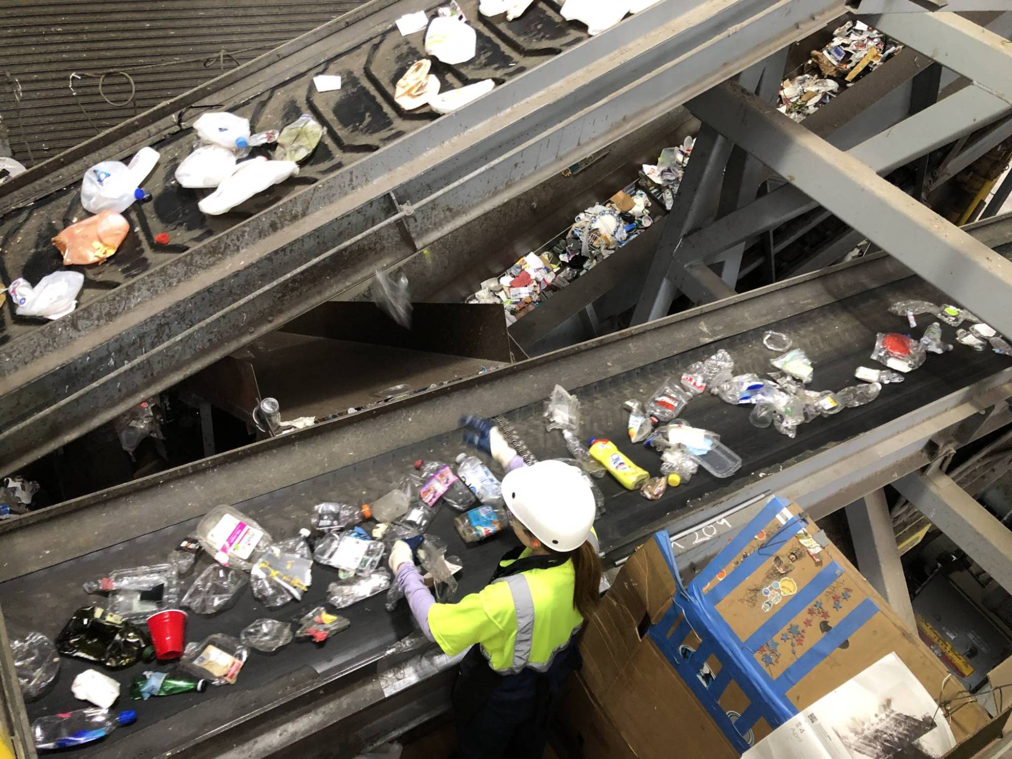 An employee sorts plastics at the Recology recycling plant on Pier 96 in San Francisco.