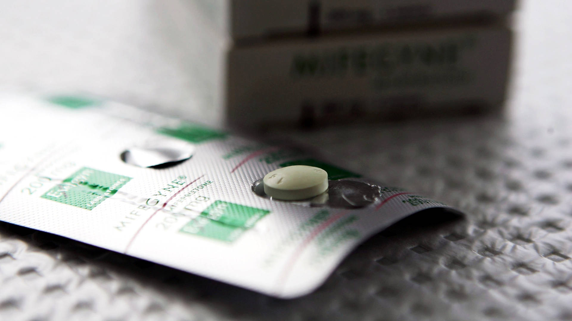 Photo of a green abortion pill.