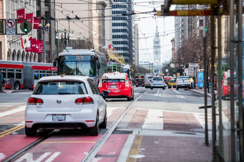 Cars drive down Market Street in San Francisco on Thursday, less than a week before the street will go car-free.