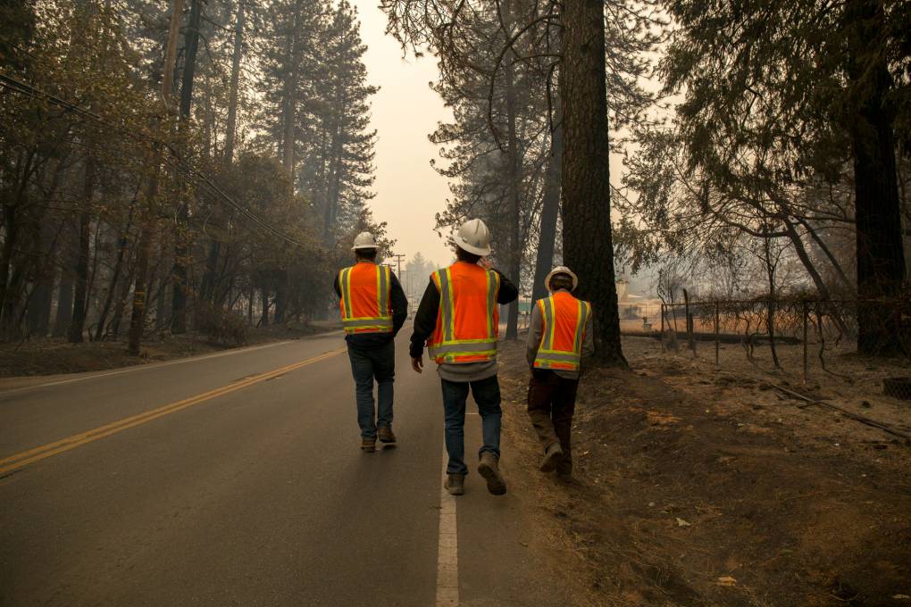 PG&E subcontractors assess vegetation at risk for catching fire near Paradise, Calif. on Nov. 13, 2018, five days after a PG&E transmission line sparked the Camp Fire, the deadliest and most destructive wildfire in modern California history. The blaze leveled the town of Paradise and killed 85 people.