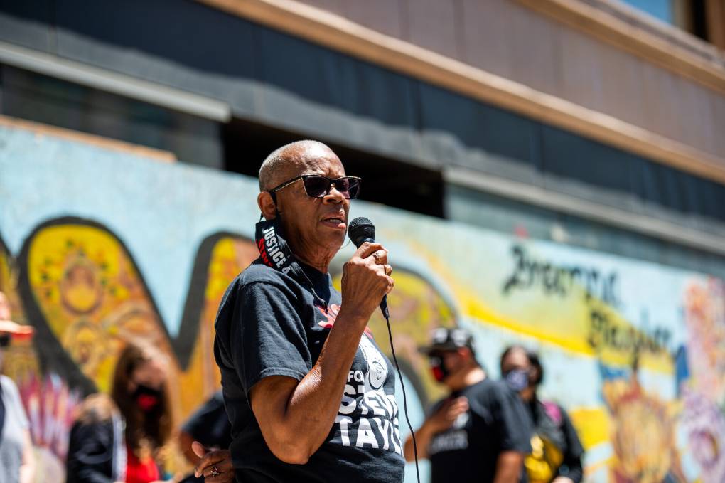 Addie Kitchen, the grandmother of Steven Taylor, speaks to a crowd in Oakland.