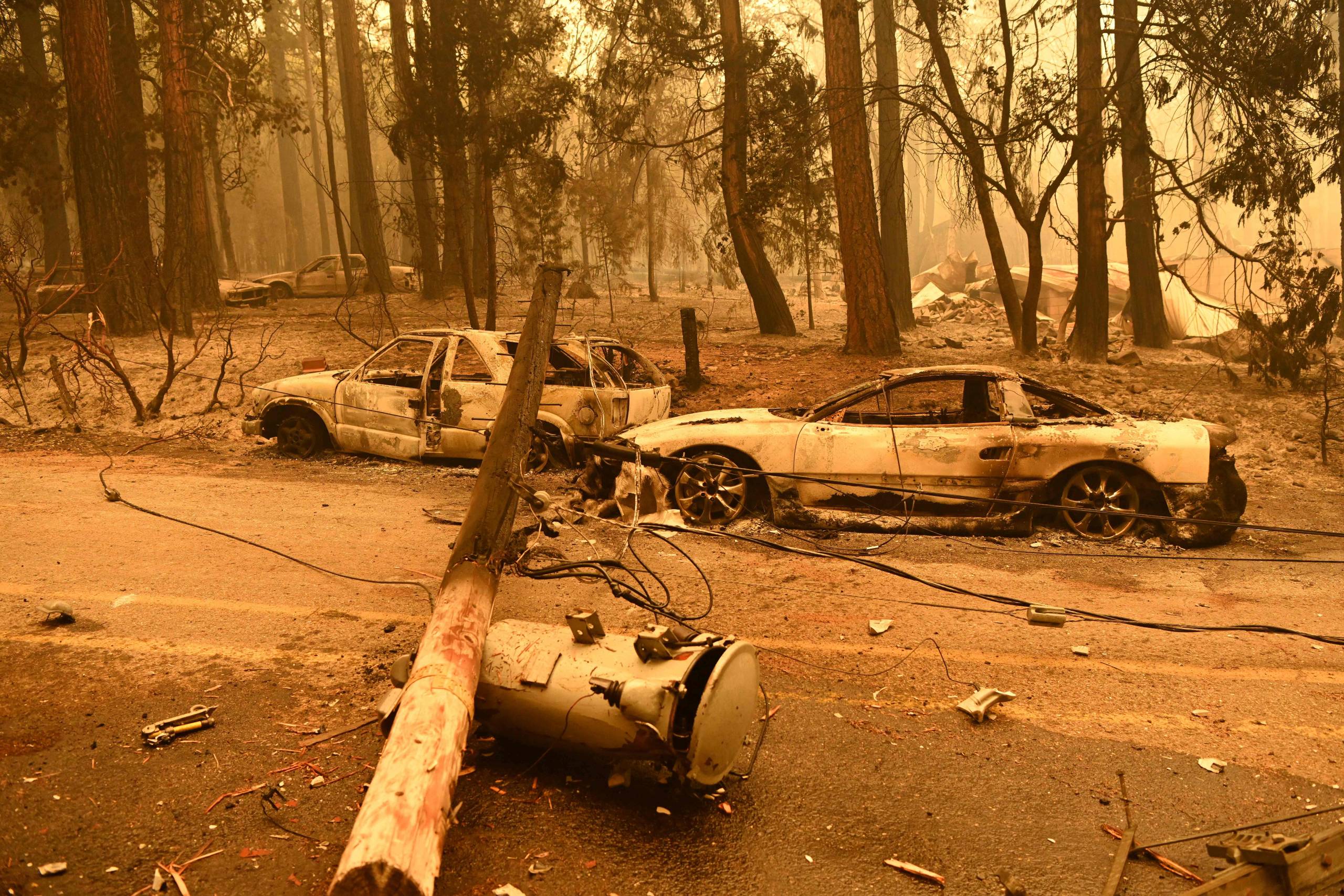 The charred remains of two cars after a fire passed by the area.