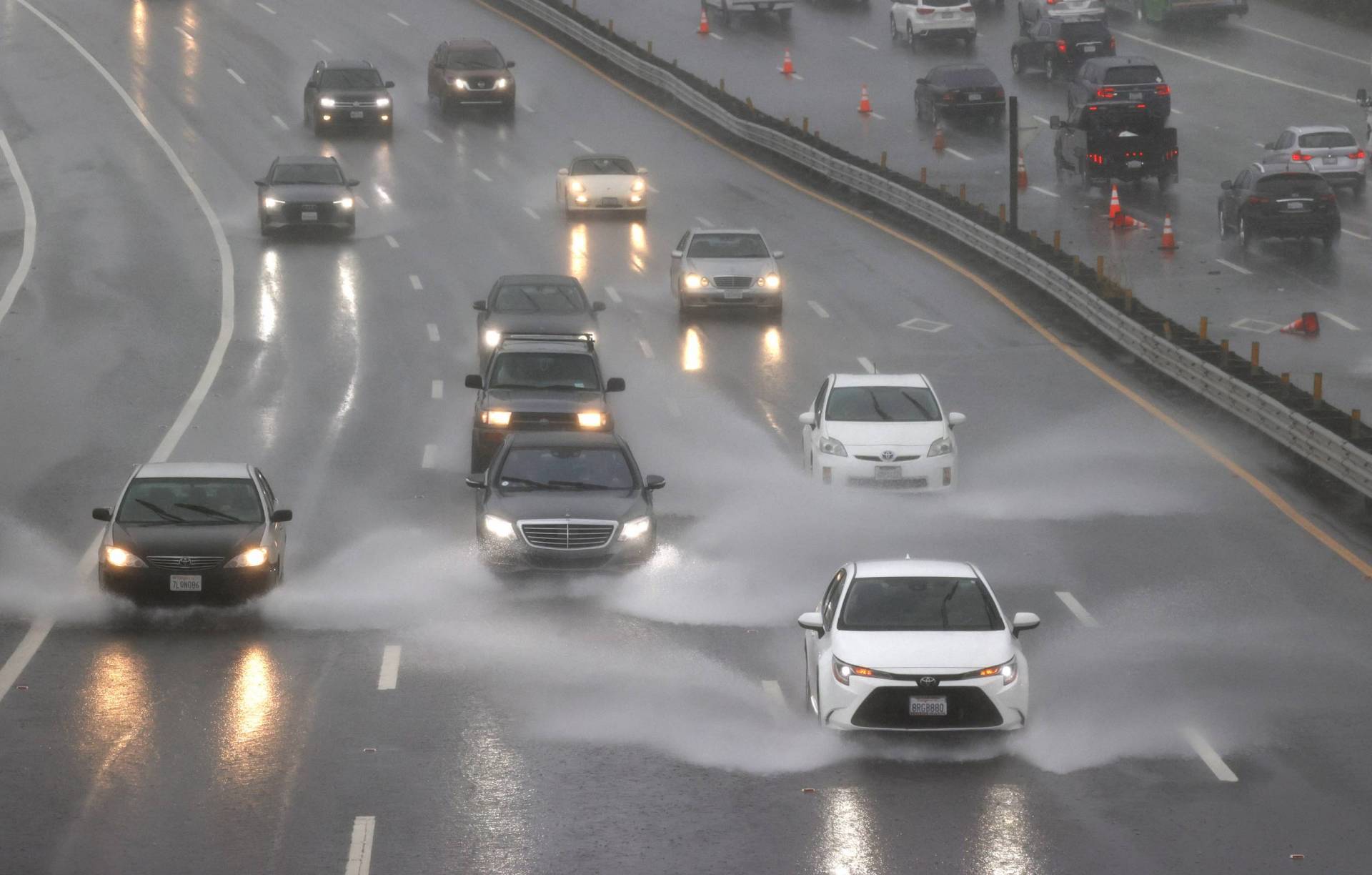 Cars drive through flooded a section of Highway 101 on October 24, 2021 in Corte Madera, California.