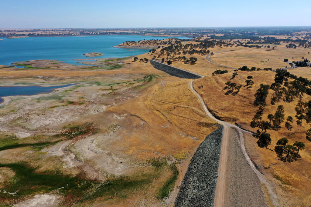 A narrow road leading to a body of water.