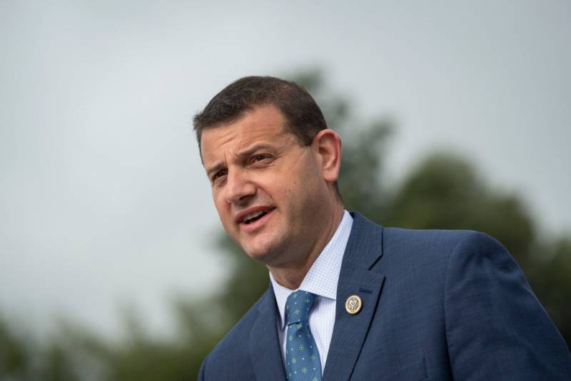 A white man in a blue suit.