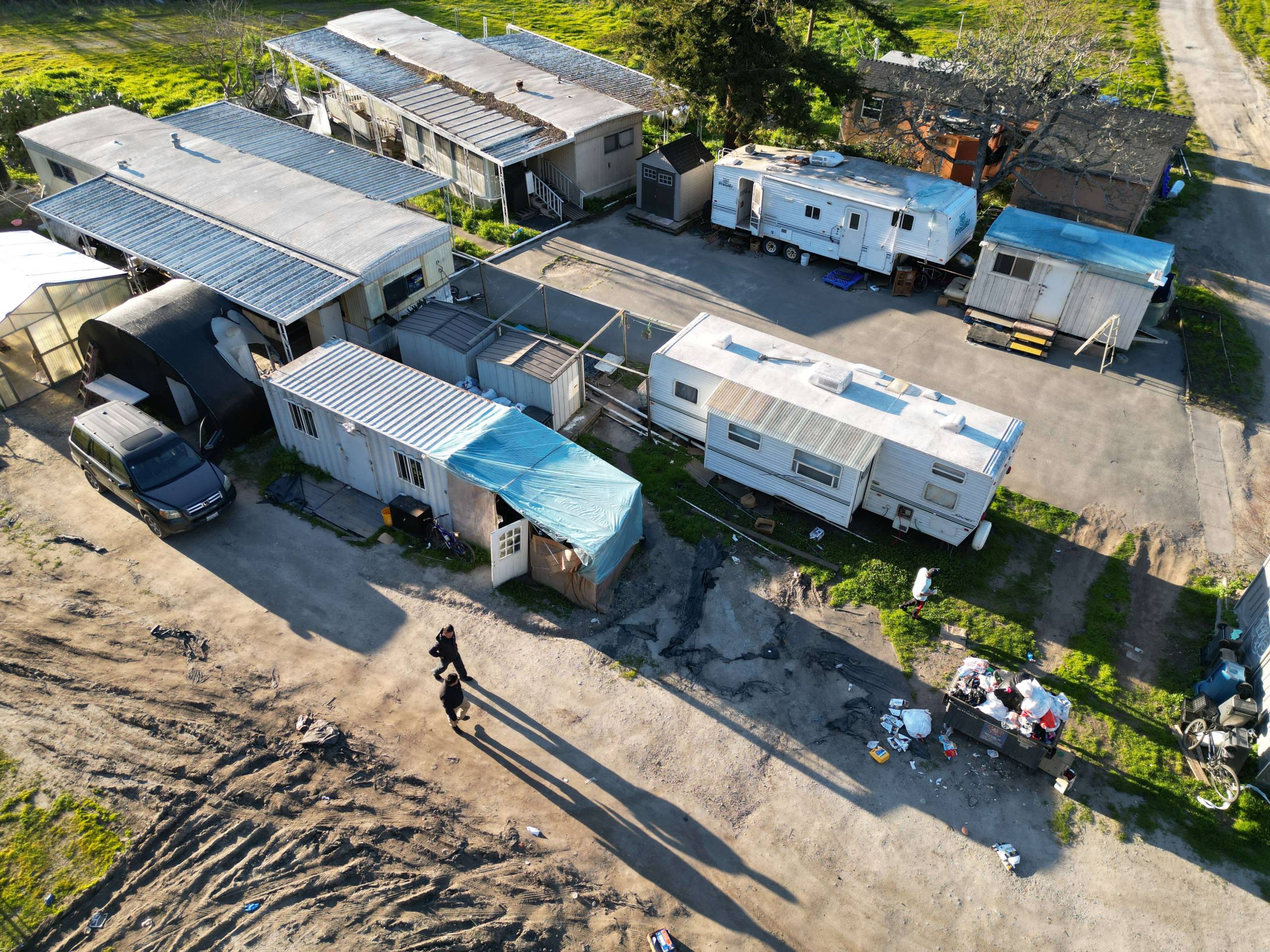 An aerial view of a number of trailers on a farm site.