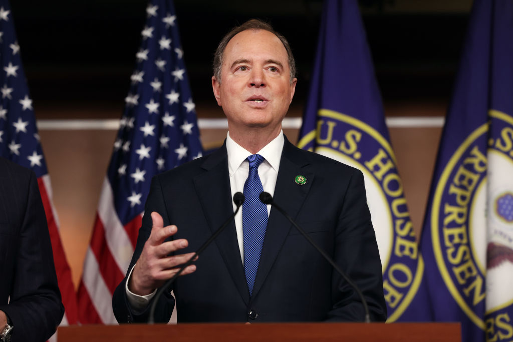 A middle-aged white man speaks into a microphone.