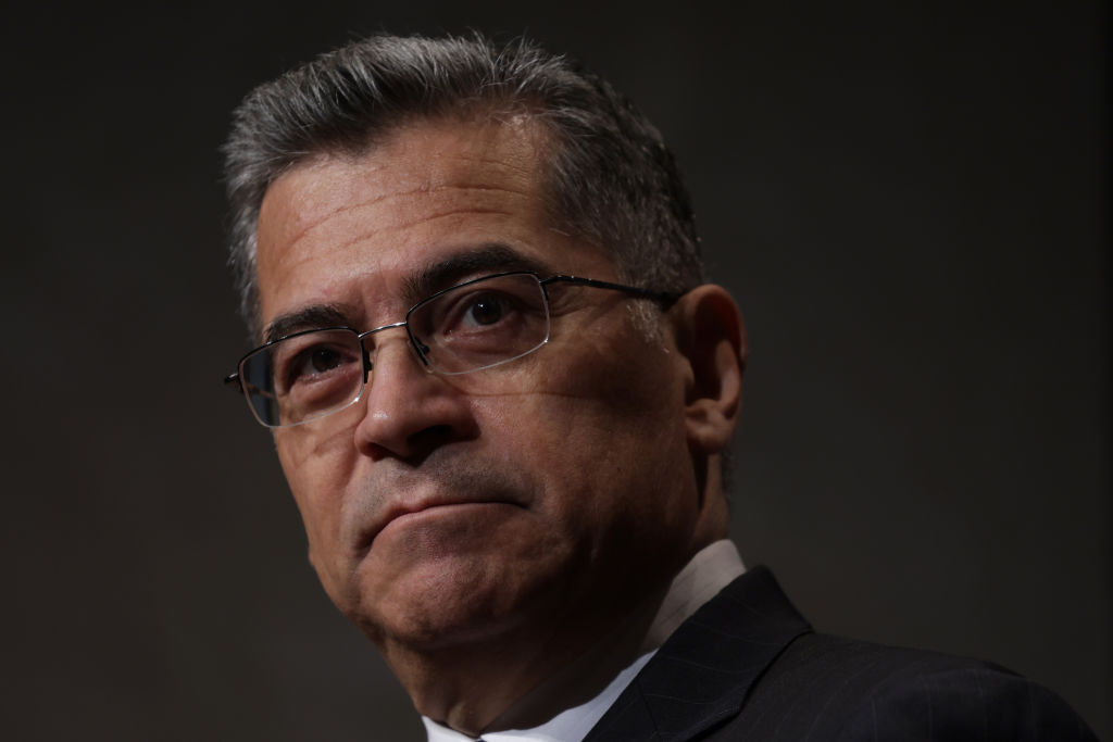 Close-up of a Latino man with glasses looking toward the camera.