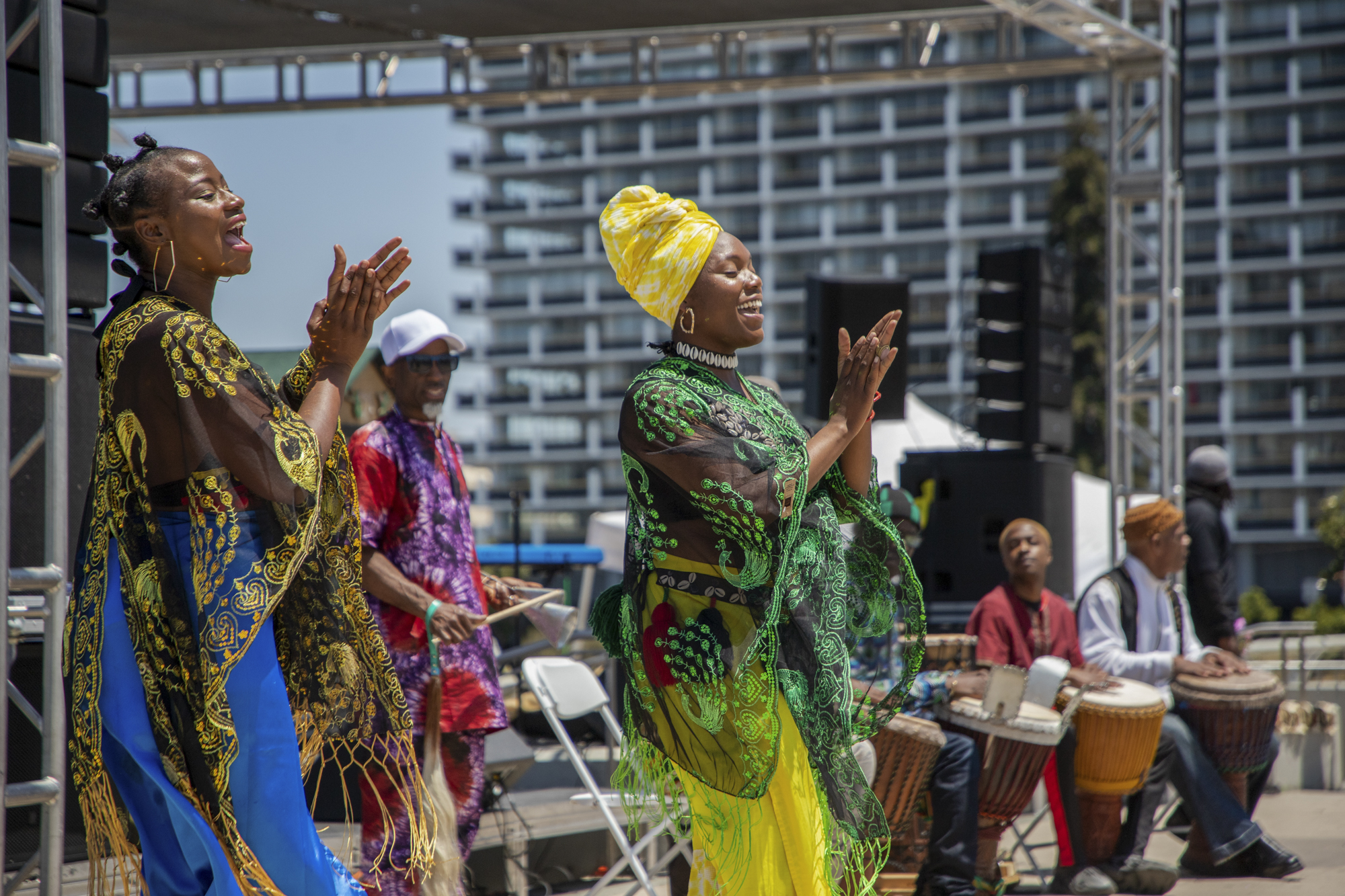 Women dance alongside a drum circle during the 14th annual Fam Bam Afrocentric Juneteenth festival in Oakland on June 17, 2023.