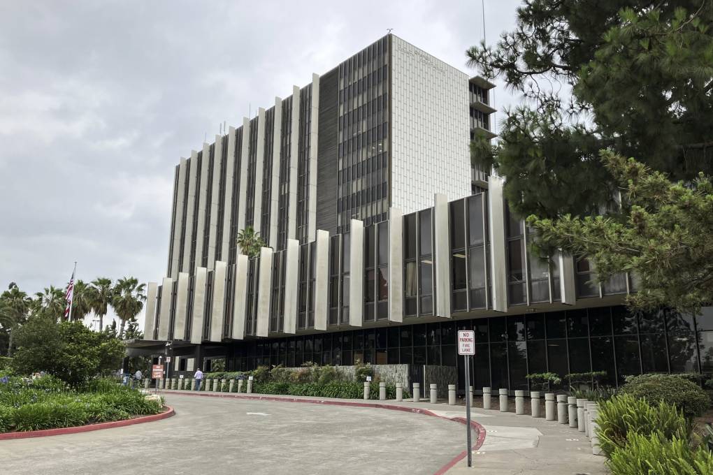 A large multi-story building and a driveway alongside it.