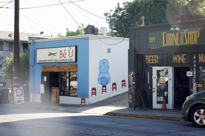 A restaurant with a blue facade on a city street.