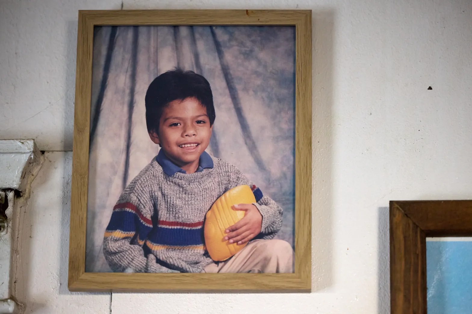 A photo of a Latino child in a picture frame.