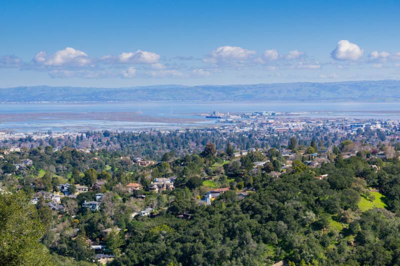 An aerial view of a city, with a large body of water in the bakground.