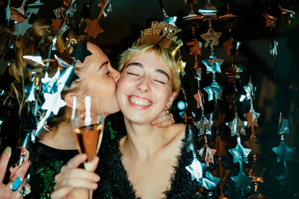 An image of two people celebrating New Year's Eve with champagne.