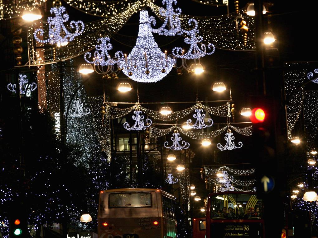 Christmas lights hang above a street