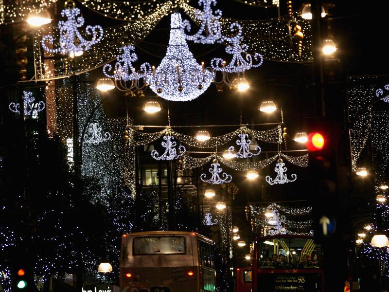Christmas lights hang above a street