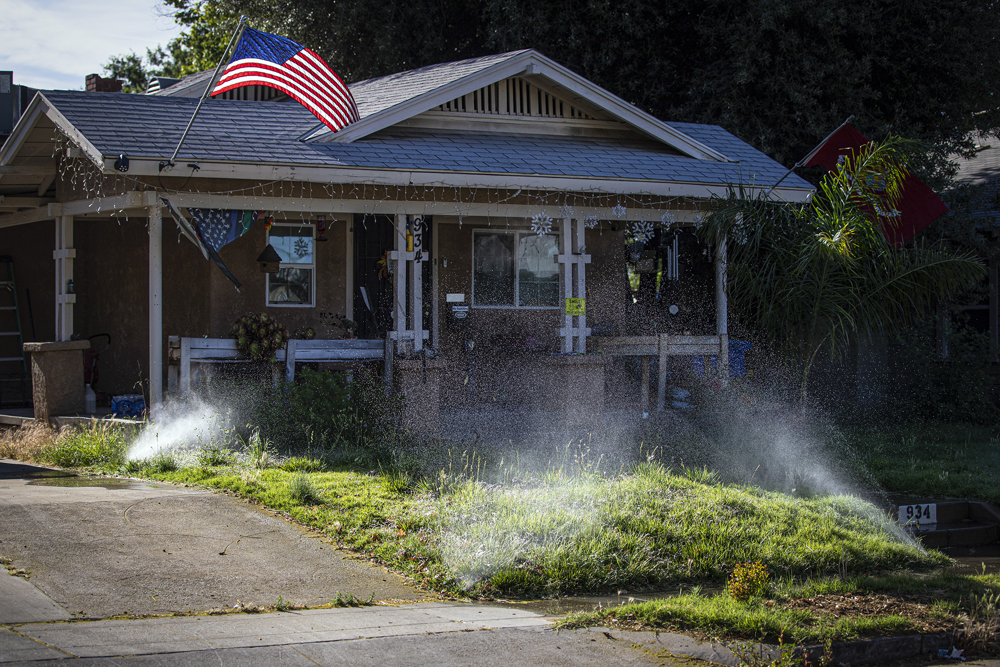 A house with sprinklers watering the lawn.