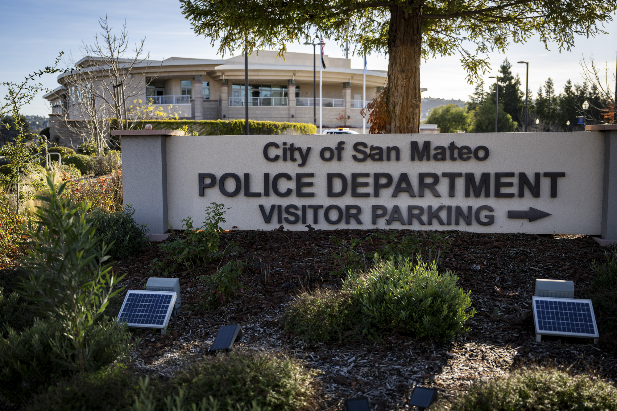 A sign outside a large building reads "City of San Mateo Police Department."