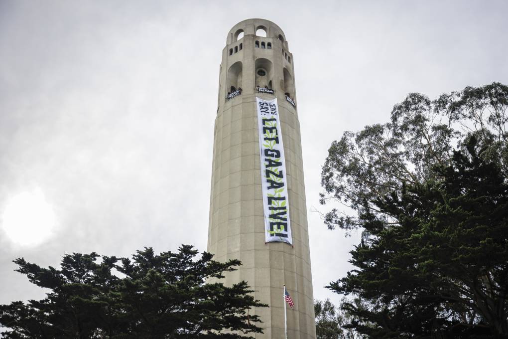 Demonstrators with If Not Now call for a ceasefire in Gaza and hang a 60-foot long banner from Coit Tower in San Francisco on Jan. 18, 2024.