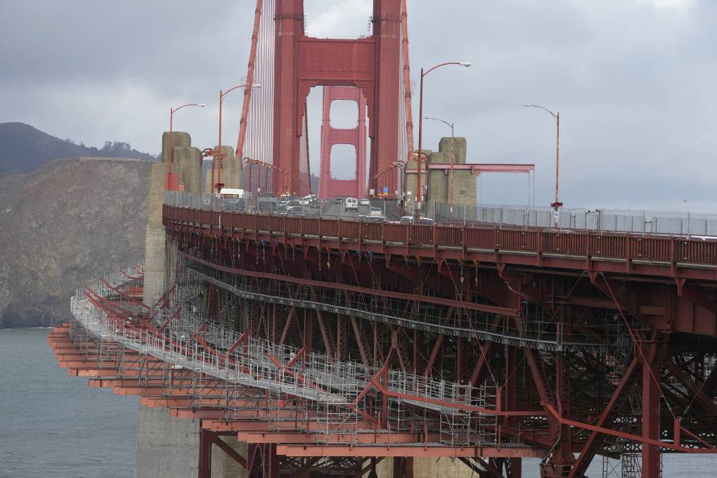 A view of a red bridge with safety nets.