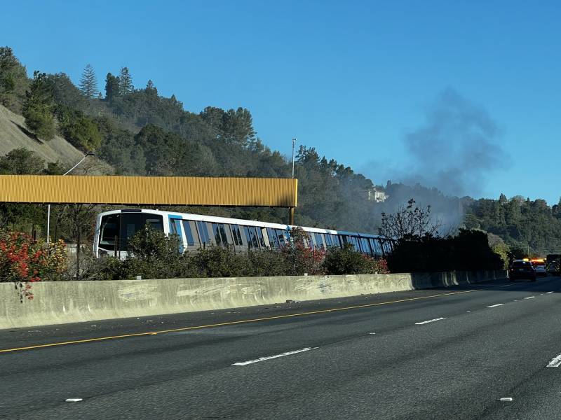 Smoke rises from a BART train.