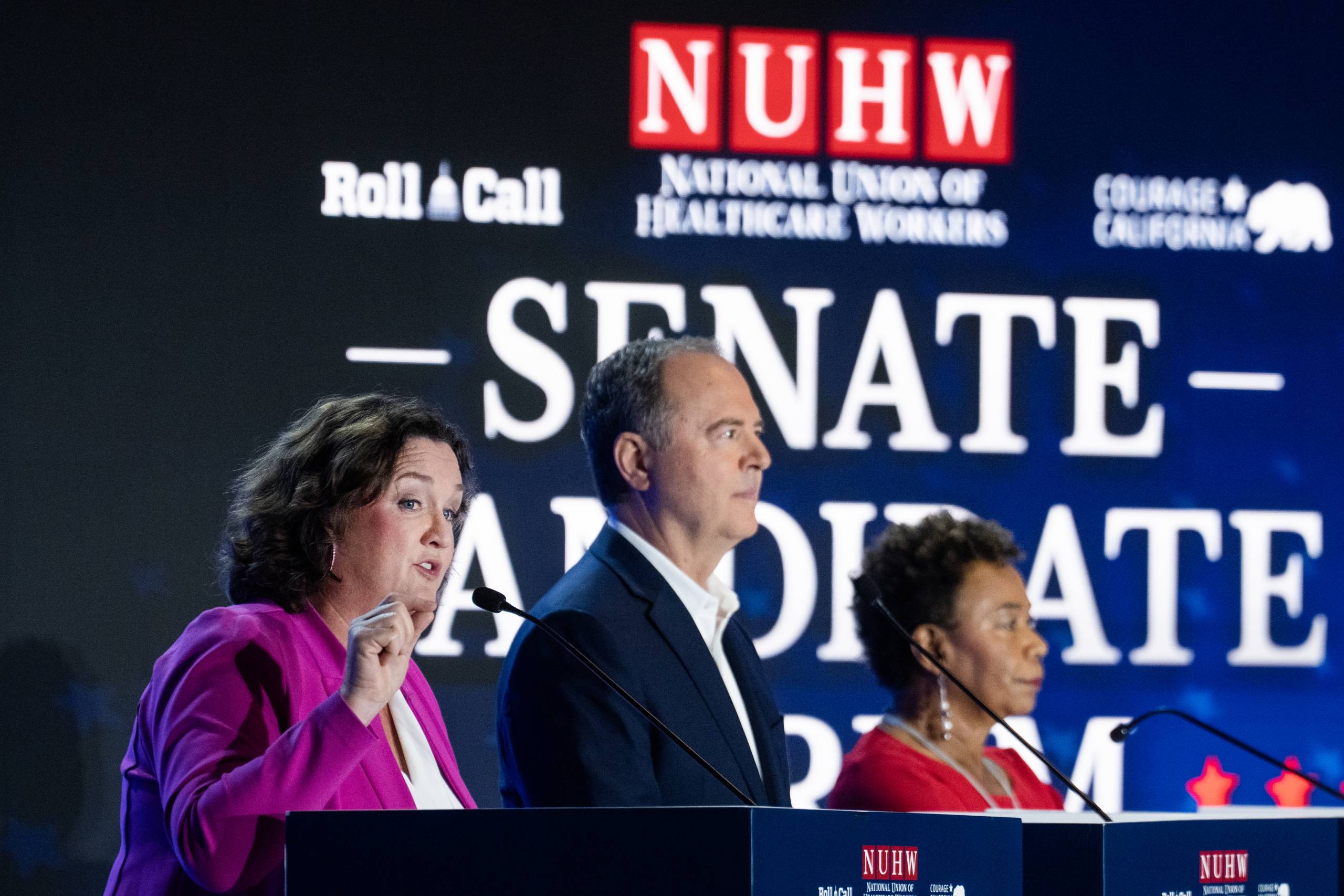 A woman a man and another woman look ahead and away from camera with "Senate Candidates" written behind them.