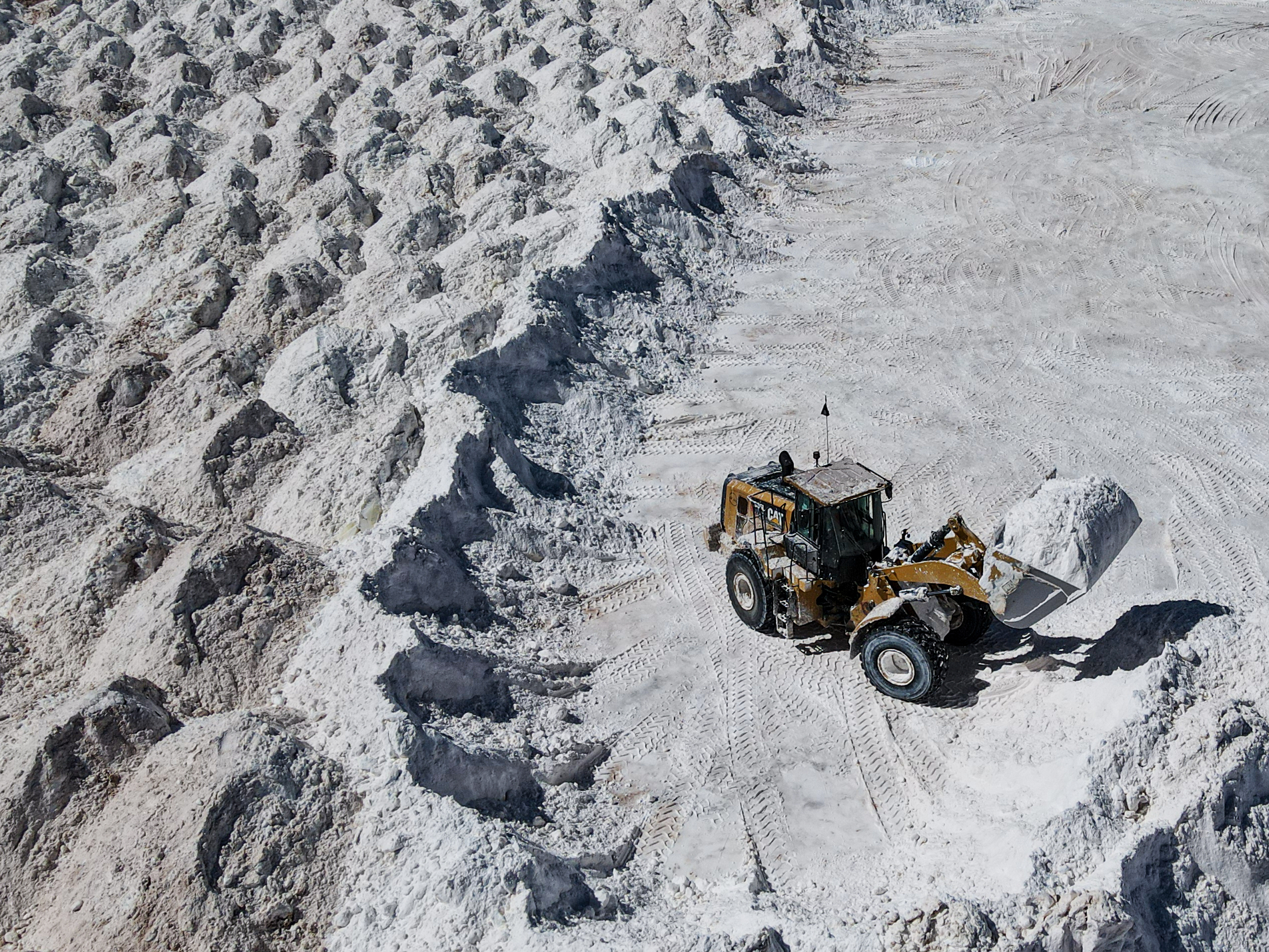 a dump truck mining a field of minerals