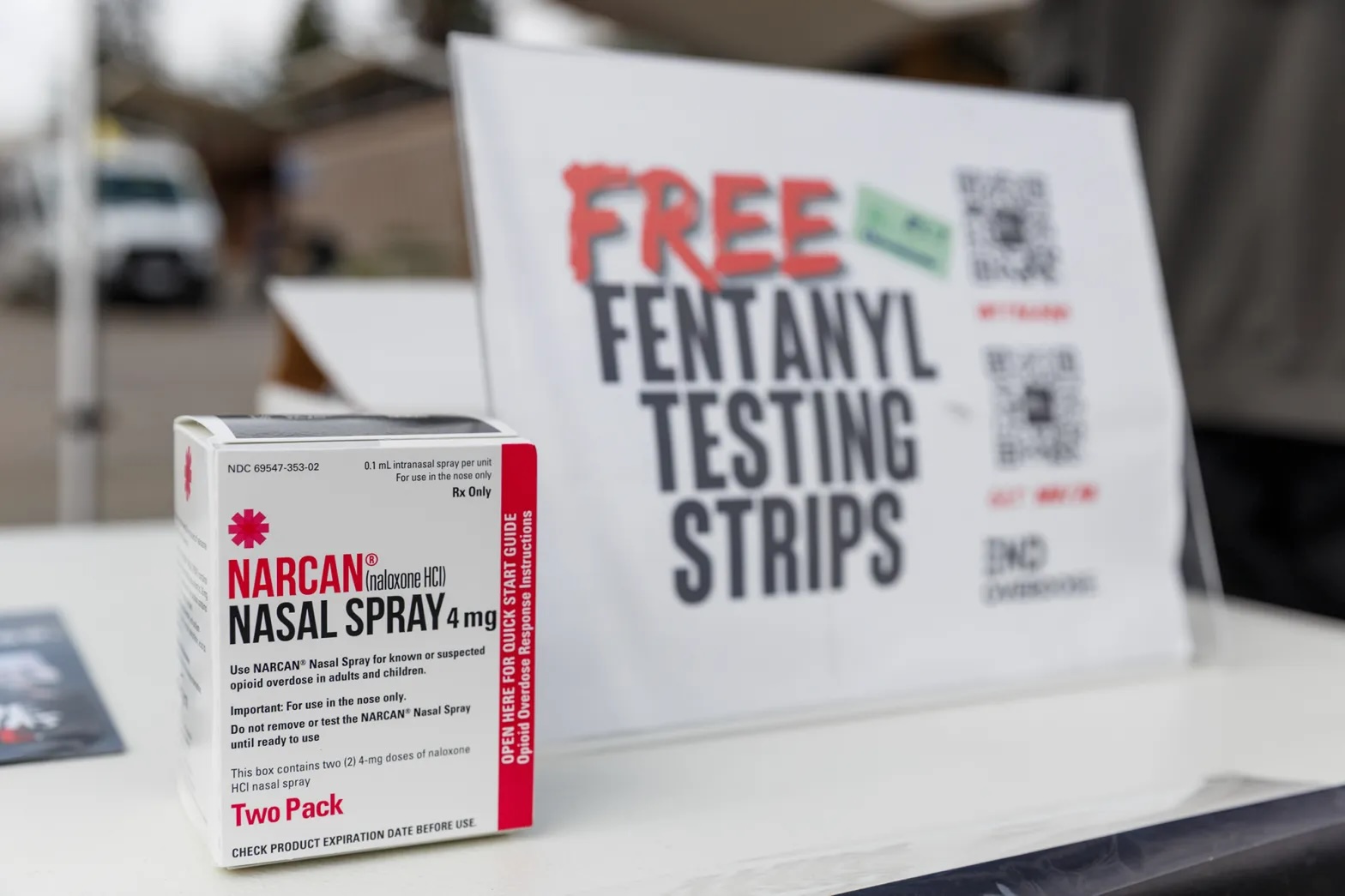 A box of medicine and a pamphlet next to it that reads "Free Fentanyl Testing Strips."