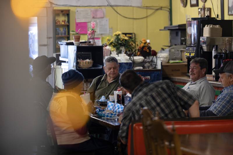 A group of men gather for lunch at Big Valley Market