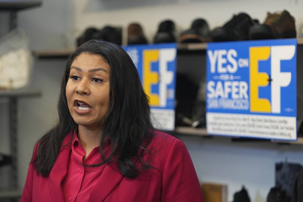 San Francisco Mayor London Breed is pictured speaking inside of a business.