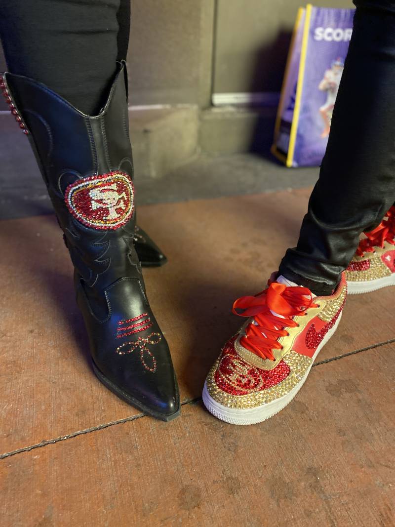 Two bedazzled shoes with red and gold 49ers colors.