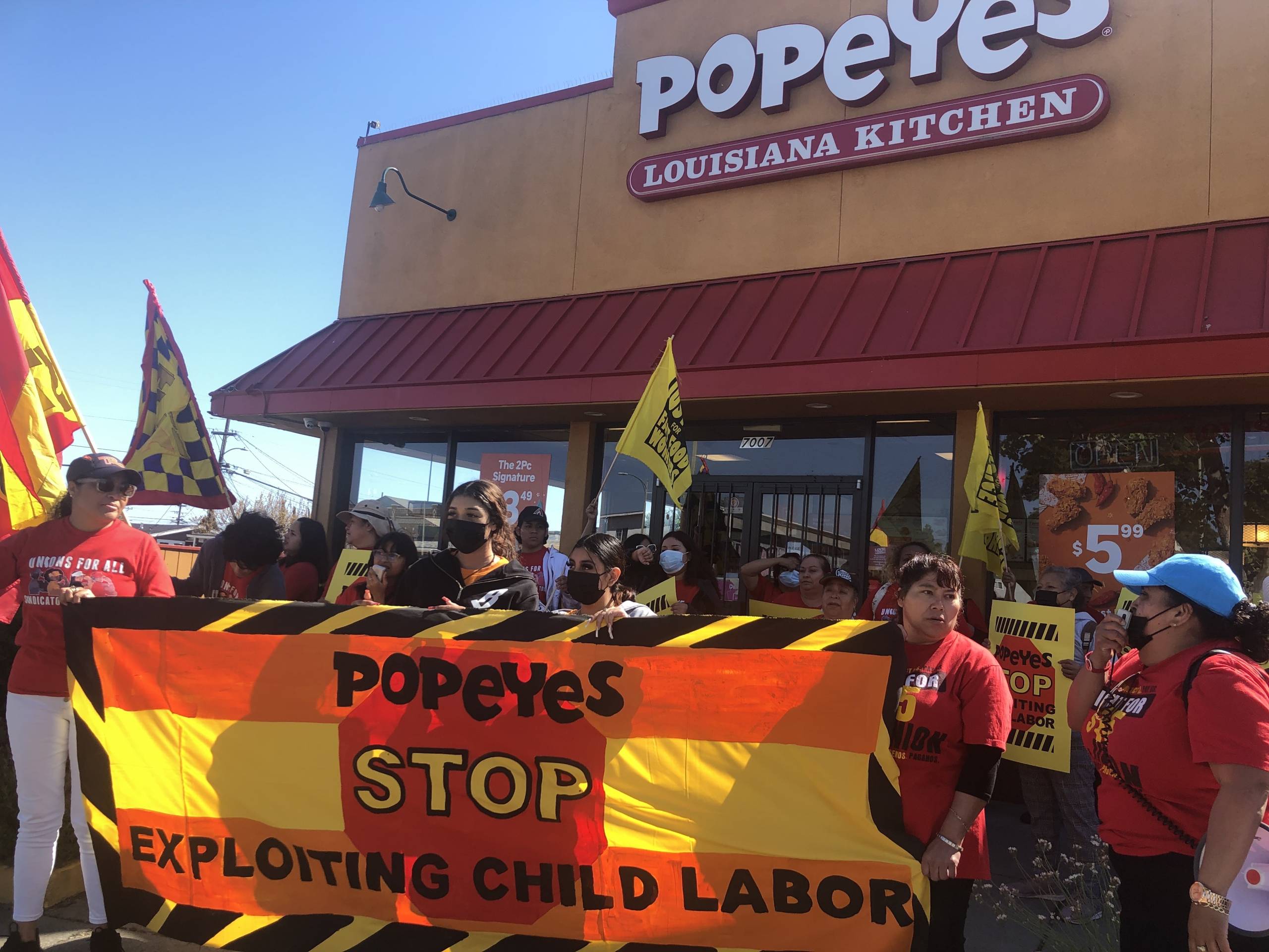 Protestors outside of a Popeyes restaurant.