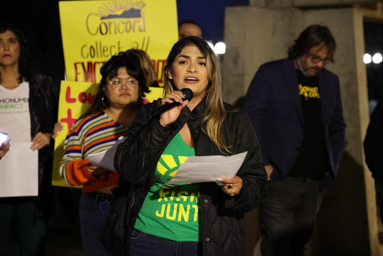 A woman speaks with a microphone.