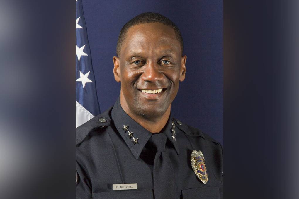 A headshot of a Black male police officer.