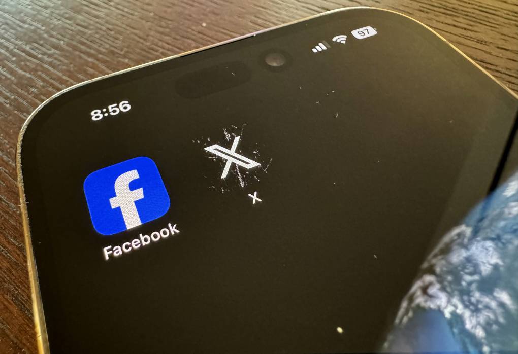 pp logos for Facebook, left, and X, formerly known as Twitter, are seen on a mobile phone.