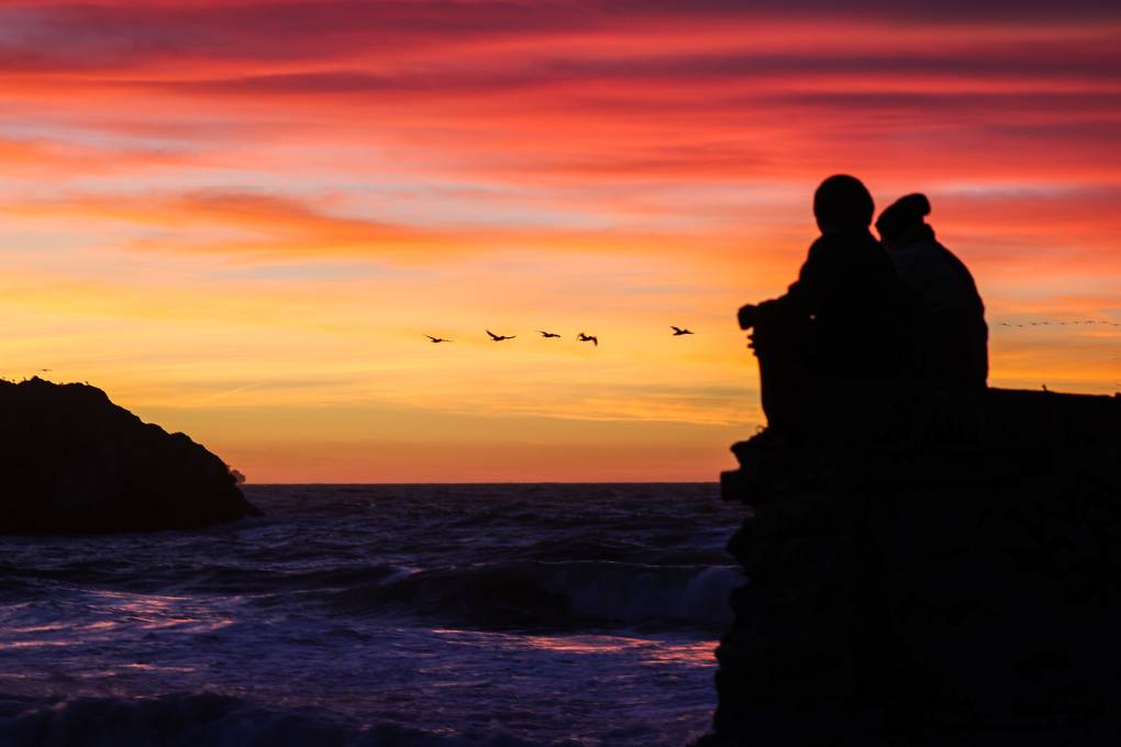 A couple enjoys the sunset by the Pacific Ocean in San Francisco, California. Tayfun Coskun/Anadolu Agency via Getty Images