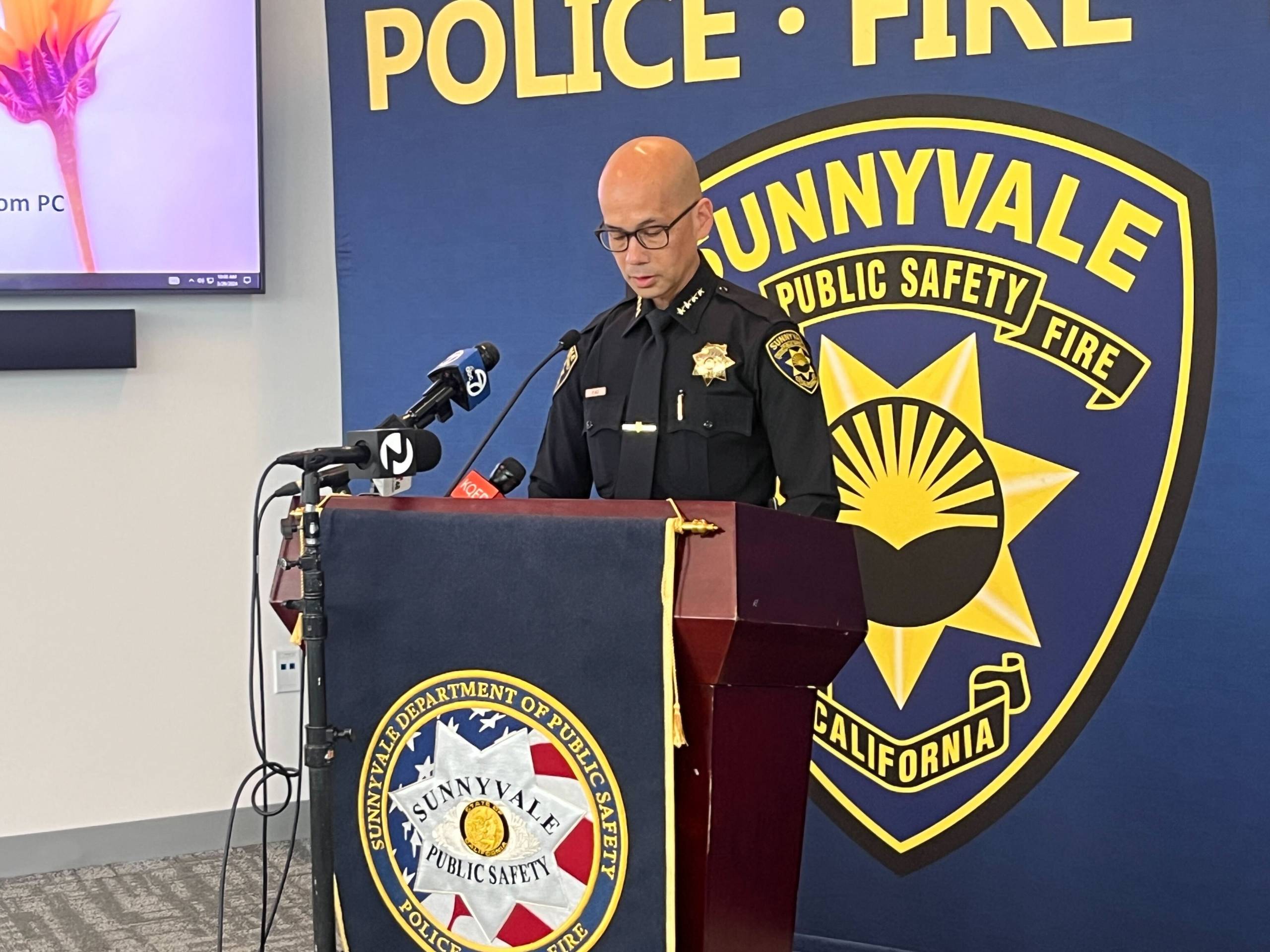 A police officer stands at a lectern.