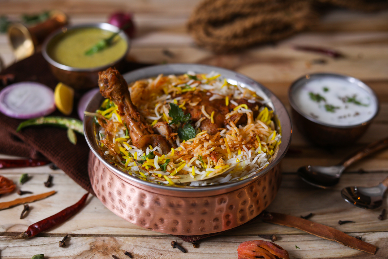 A food dish filled with rice and meat.