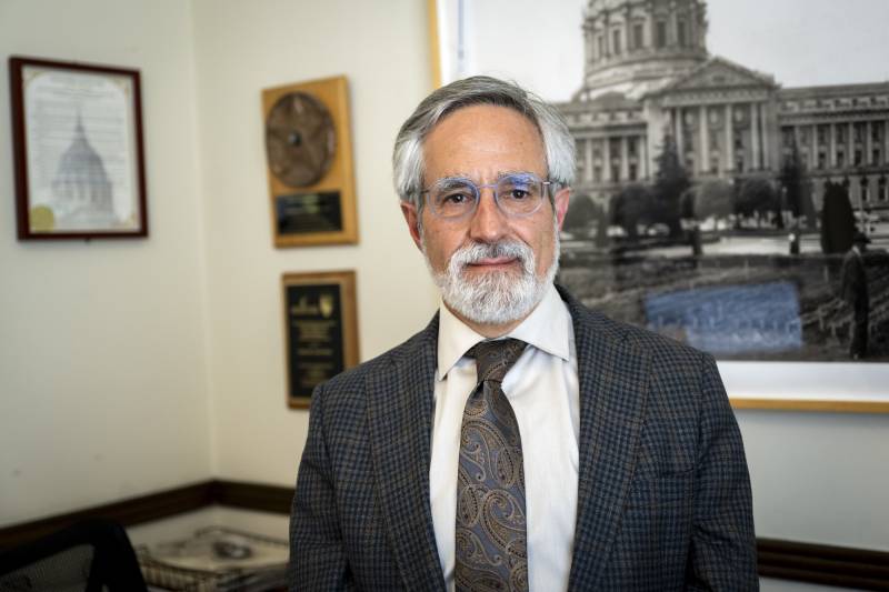 an older man in a suit and glasses