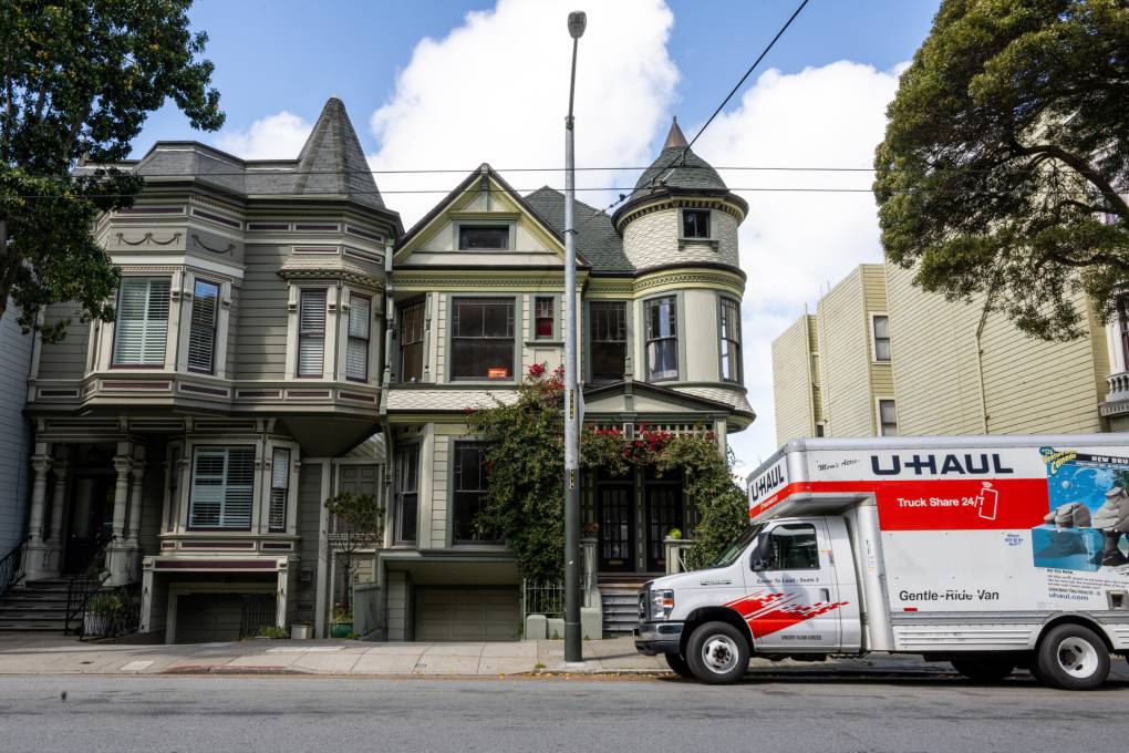A U-Haul van parked in front of a home.