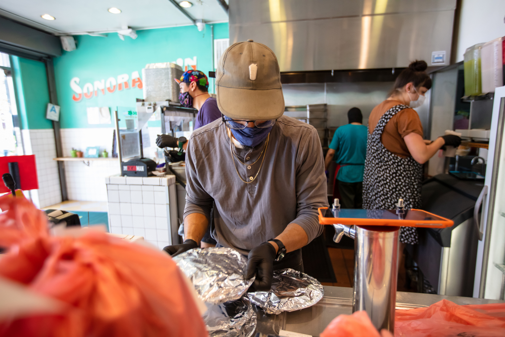 workers prepare plates of food in a restaurant kitchen