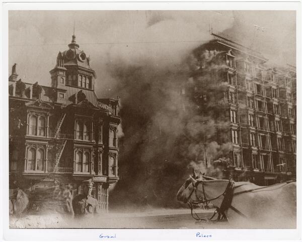 Black and white photo of two grand buildings collapsing.